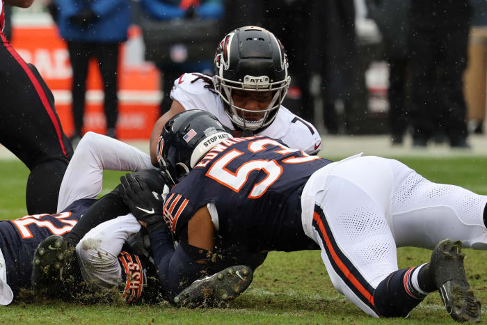 Dec 31, 2023; Chicago, Illinois, USA; Chicago Bears linebacker T.J. Edwards (53) makes a tackle on Atlanta Falcons running back Bijan Robinson (7) during the first half at Soldier Field.